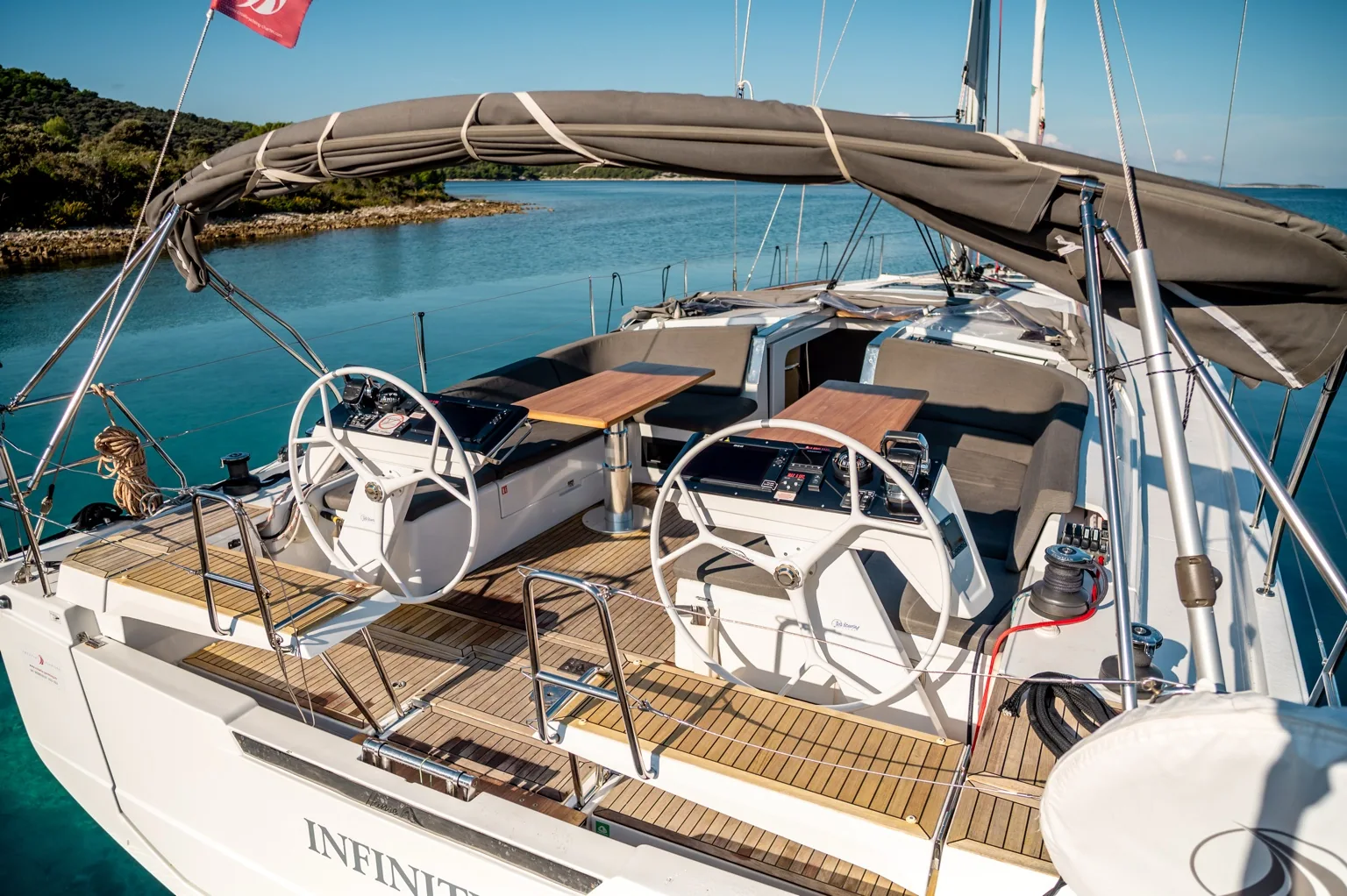 Infinity cockpit with both helm stations and teak seating